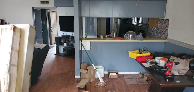 kitchen with hardwood / wood-style flooring and stainless steel fridge