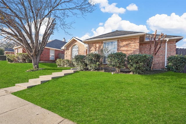 ranch-style home with a front lawn