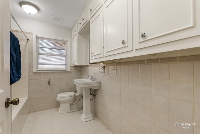 bathroom featuring tile patterned floors and toilet