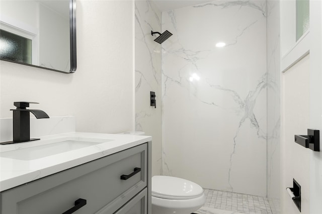 bathroom featuring walk in shower, vanity, and toilet