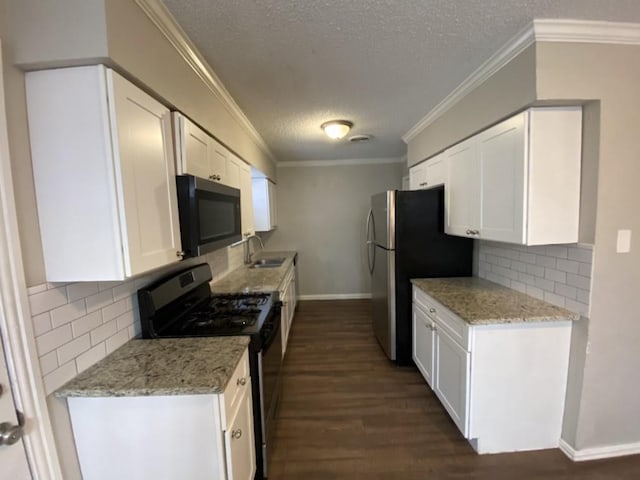 kitchen featuring black range with gas stovetop, white cabinetry, tasteful backsplash, and light stone counters