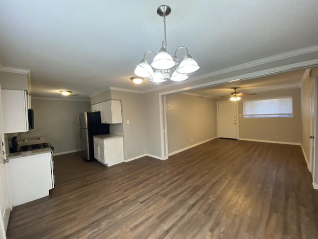 kitchen featuring stainless steel fridge, white cabinetry, and crown molding