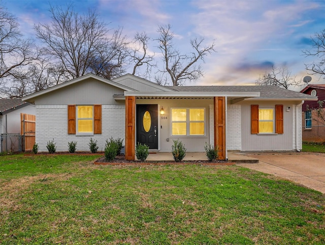 ranch-style house featuring a yard