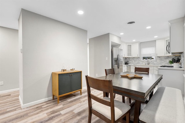 dining room featuring light hardwood / wood-style flooring and sink