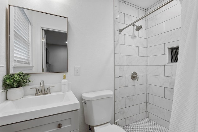 bathroom with toilet, vanity, and curtained shower