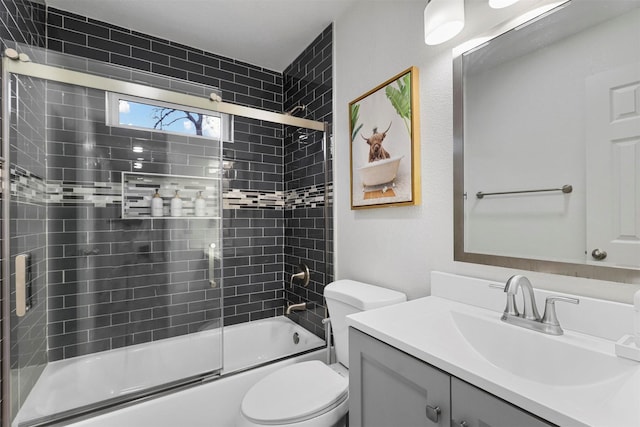 full bathroom with shower / bath combination with glass door, vanity, and toilet