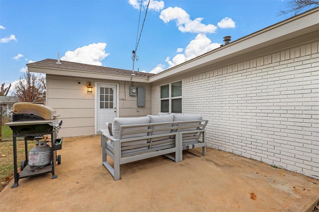 rear view of property featuring an outdoor living space and a patio area