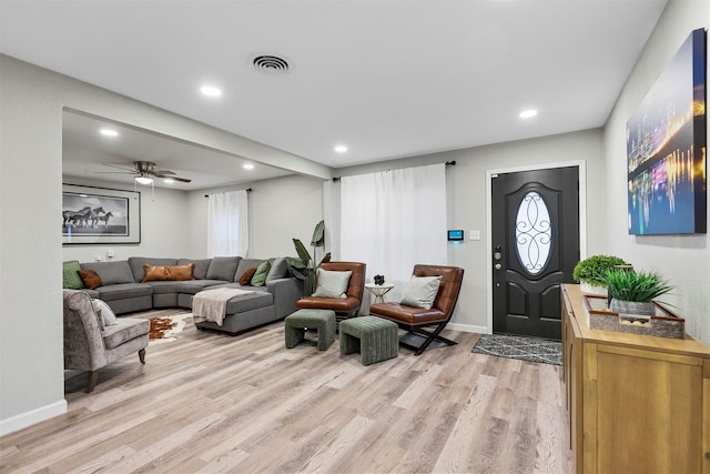 living room featuring light hardwood / wood-style floors and ceiling fan