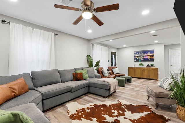 living room with ceiling fan and light wood-type flooring