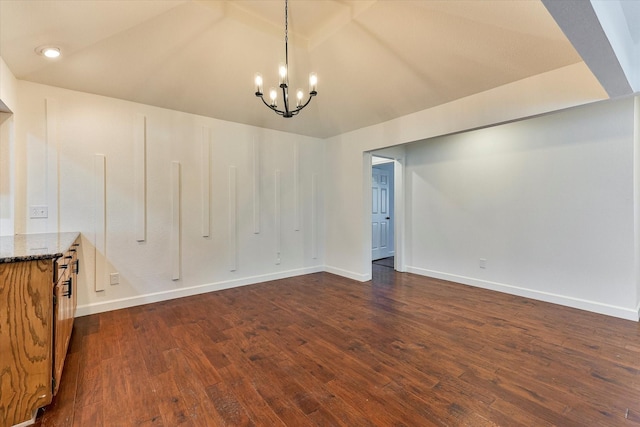 interior space with lofted ceiling, dark wood-type flooring, and an inviting chandelier