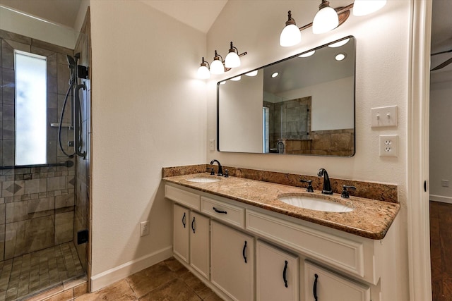 bathroom with lofted ceiling, an enclosed shower, and vanity