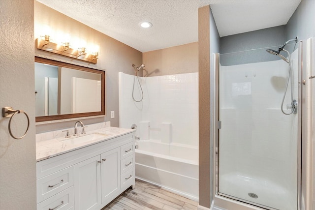 bathroom featuring vanity, hardwood / wood-style floors, and a textured ceiling