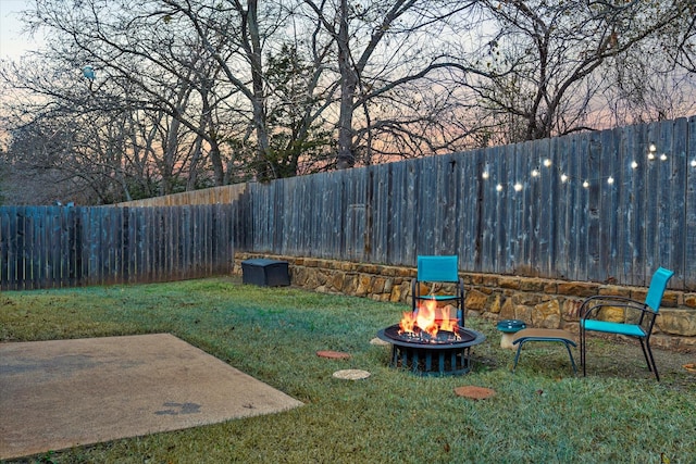 view of yard with an outdoor fire pit