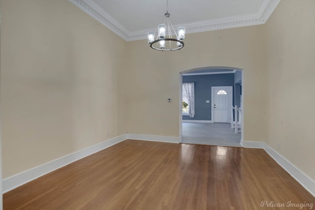 unfurnished dining area featuring ornamental molding, a chandelier, and hardwood / wood-style floors