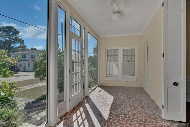 unfurnished sunroom with plenty of natural light and ceiling fan