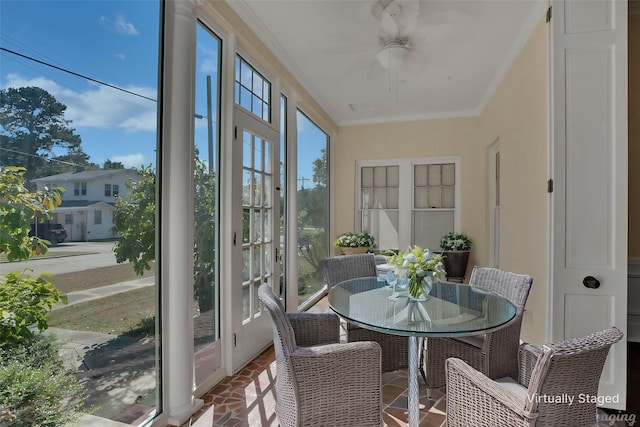 sunroom / solarium featuring ceiling fan