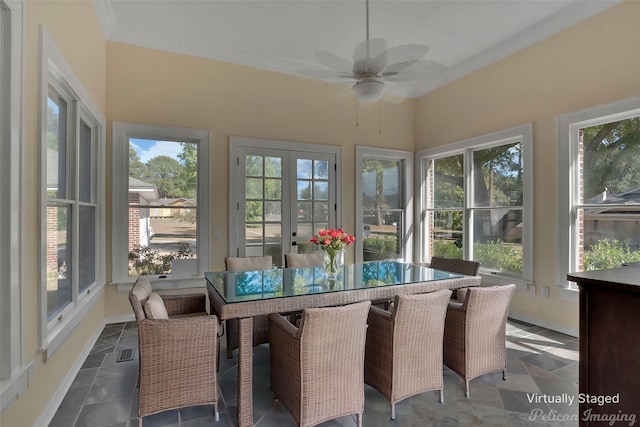 sunroom / solarium with ceiling fan and french doors