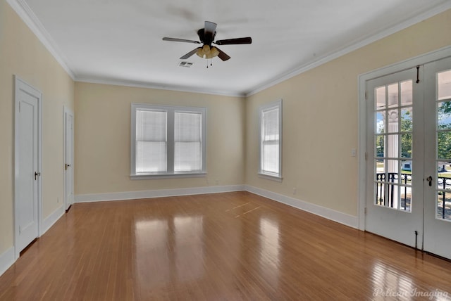 unfurnished room featuring crown molding, plenty of natural light, light wood-type flooring, and french doors