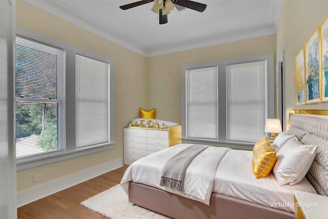 bedroom featuring crown molding, hardwood / wood-style flooring, and ceiling fan