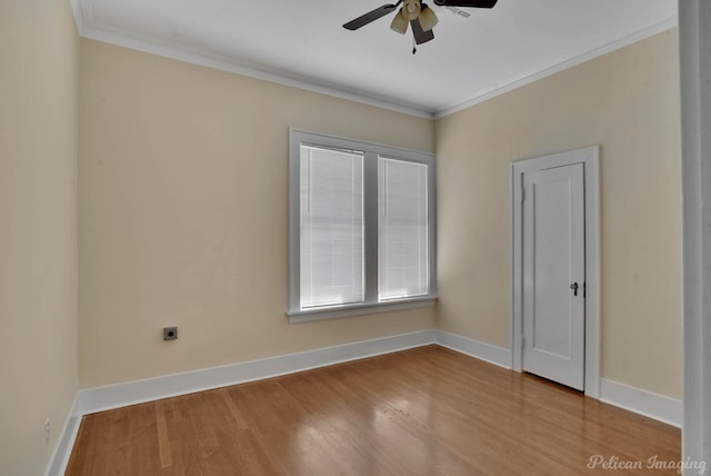 empty room featuring ceiling fan, ornamental molding, and wood-type flooring