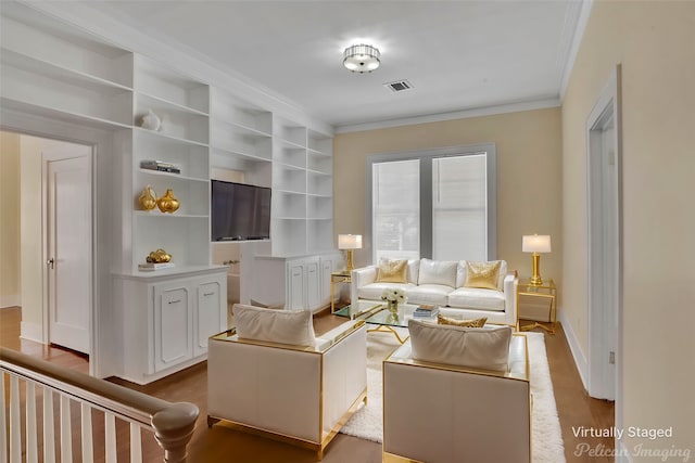 living room featuring hardwood / wood-style flooring and ornamental molding