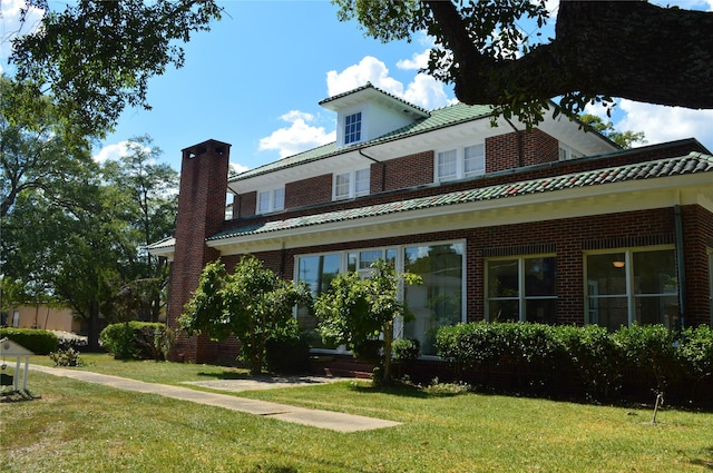 view of side of property with a yard