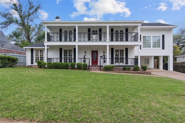 view of front of house featuring a balcony, a front yard, and a porch