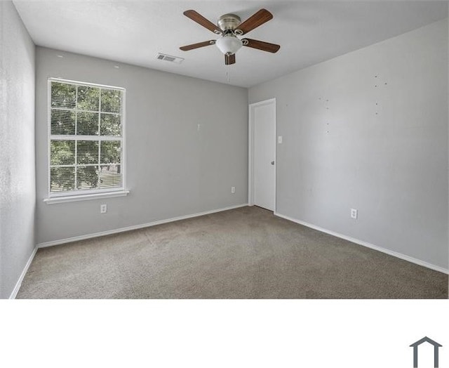 carpeted spare room with ceiling fan