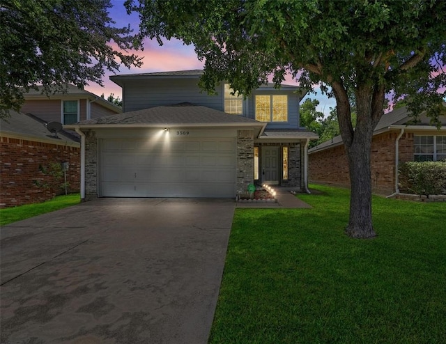 view of property featuring a lawn and a garage