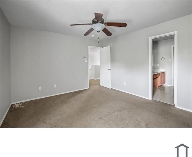 unfurnished bedroom featuring ensuite bathroom, light colored carpet, and ceiling fan