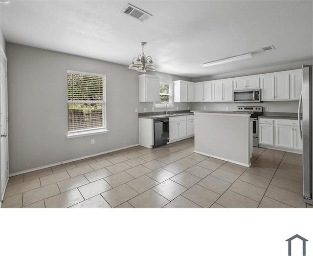 kitchen with white cabinets, stainless steel appliances, decorative light fixtures, and a chandelier