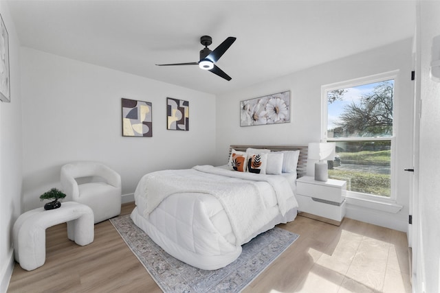 bedroom with ceiling fan and light wood-type flooring