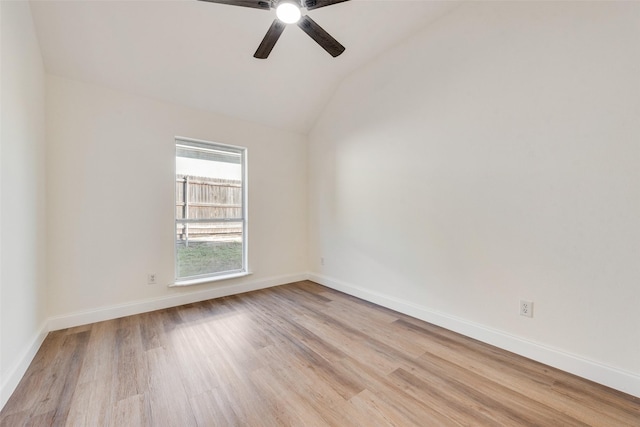 spare room featuring ceiling fan, light wood-type flooring, and vaulted ceiling