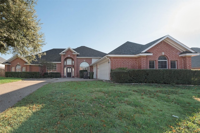 view of front of property featuring a front lawn and a garage