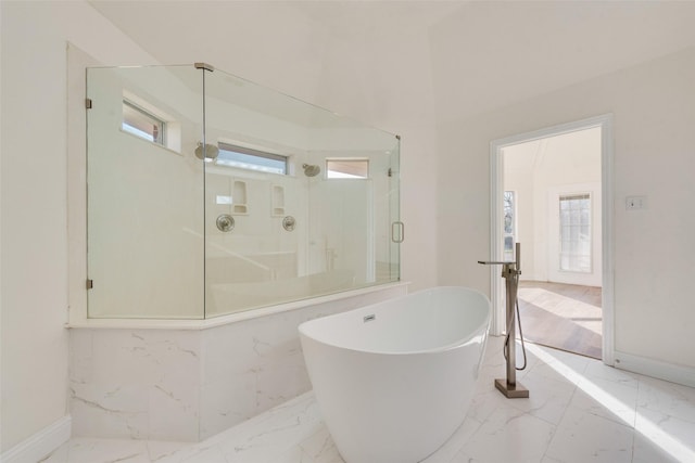 bathroom featuring independent shower and bath and plenty of natural light