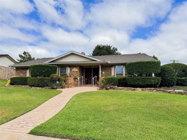 ranch-style home with a front lawn and brick siding