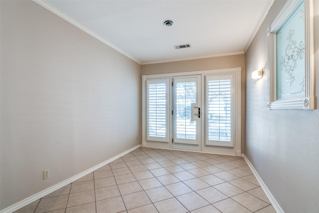 empty room with visible vents, crown molding, baseboards, and light tile patterned flooring