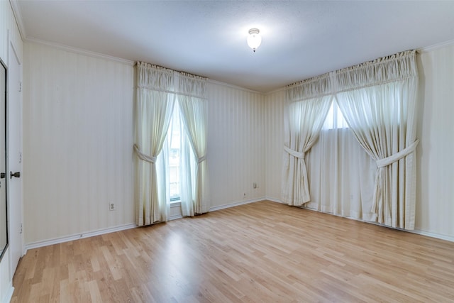 spare room featuring light wood-style flooring and baseboards