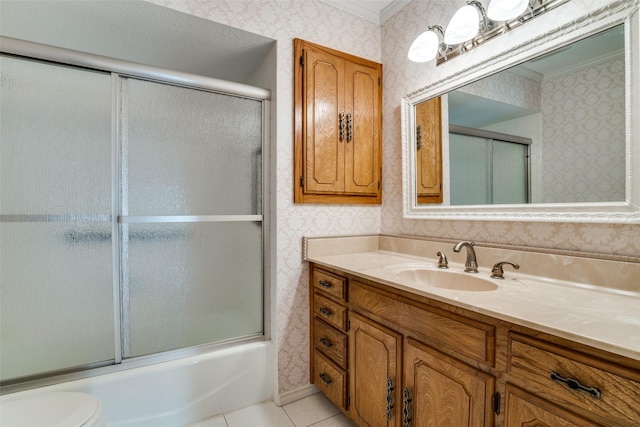 bathroom featuring wallpapered walls, tile patterned flooring, combined bath / shower with glass door, and vanity