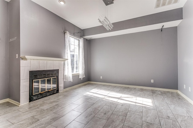 unfurnished living room with visible vents, a fireplace, and baseboards