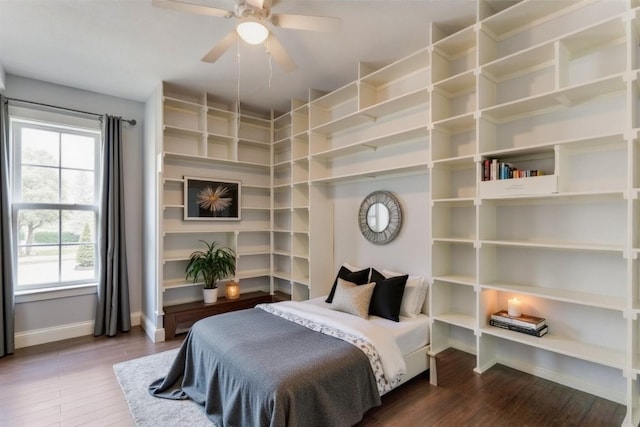 bedroom featuring multiple windows, wood finished floors, and baseboards