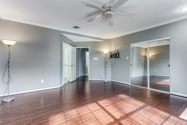 interior space featuring visible vents, crown molding, baseboards, and wood finished floors