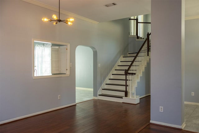 interior space featuring arched walkways, visible vents, crown molding, and wood finished floors