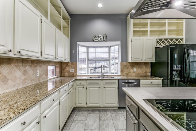 kitchen with white cabinetry, sink, cooktop, black fridge with ice dispenser, and range hood