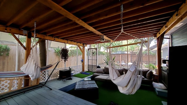 dock area with a deck, outdoor lounge area, and a fenced backyard