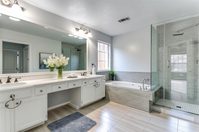 bathroom featuring a garden tub, a sink, visible vents, and a shower stall