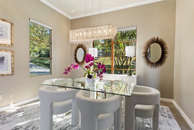 dining room featuring an inviting chandelier, crown molding, and a wealth of natural light