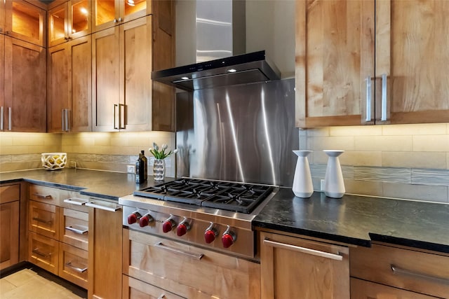 kitchen featuring light tile patterned floors, stainless steel gas cooktop, tasteful backsplash, and wall chimney exhaust hood