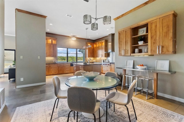 dining room with crown molding and sink