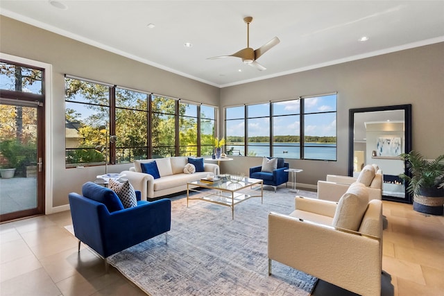 tiled living room featuring ceiling fan, ornamental molding, and a water view